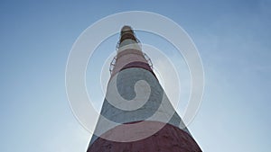 Bottom View and Motion around High Red and White Chimney
