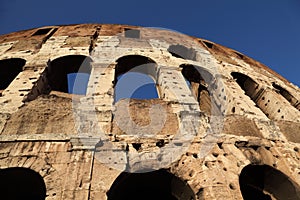 Bottom view on old stone walls of Coliseum