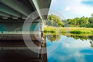 Bottom view of the reinforced concrete bridge over the river. Bridge piers