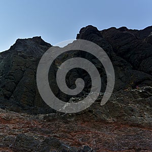 Bottom view of rocks with blue sky at background