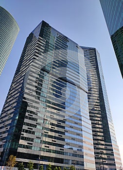 Bottom view on skyscraper and blue sky. Modern office building