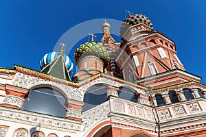 Bottom view of St. Basil`s Cathedral with painted domes against a blue sky. Summer sunny day. Moscow, Russia