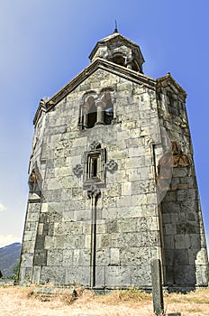 Bottom view on of the tall tower the bell tower in the monastery of Haghpat