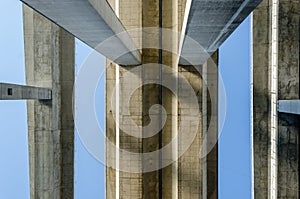Bottom view of three concrete bridge decks and they columns