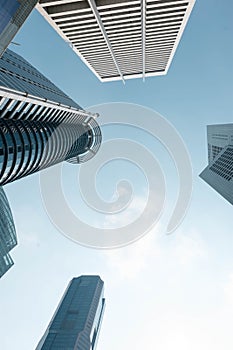 Bottom view to modern skyscrapers at downtown district. Business below background. Singapore city