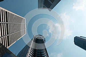 Bottom view to modern skyscrapers at downtown district. Business below background. Singapore city