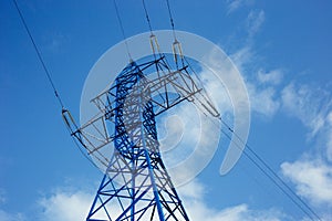 bottom view of the tower of power grids on blue sky background, High voltage, Electricity concept photo
