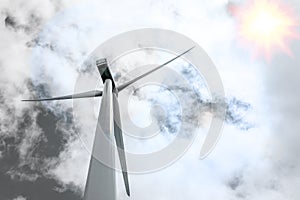 Bottom view of wind turbine generating electricity clean energy with cloud and sunlight background on the sky. Clean