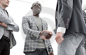 Bottom view.young businessman shaking hands with his business partner