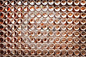 Bottoms of brown beer bottles group patterns texture on wall abstract for background