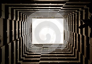 Bottoms up view of the cascading rectangular corridors balcony opening up of residential buildings against the white sky