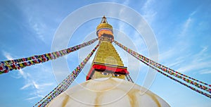 Boudhanath stupa, eyes, prayer flags, blue sky, Kathmandu, Nepal