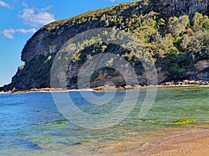 Boudi national park beach with blue clear sky surrounding sea and lots of greenness photo