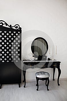 Boudoir table. Details of the interior of the modern black and white bedroom for girls and make-up, hairstyles with a