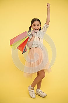 Bought new dress. Girl shopaholic likes shopping on sale season. Child cute fashionista shopping. Kid girl happy smiling