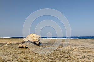 Boulder on deserted beach