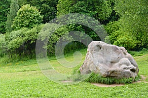 Boulder and footpath. The big boulder closeup and footpath in  park in sunny summer day