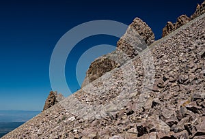 Boulder Jut To Blue Sky Along Steep Slope of Lassen Peak