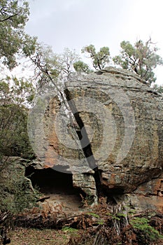 Boulder with a large crack on a cliff