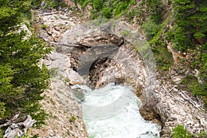 Boulder River flowing through rocky chasm in Montana photo