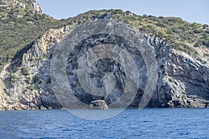 boulder and steep cliffs near Uomo cape, Argentario, Italy photo