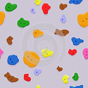 Bouldering rock climbing wall at the sports training gym. Seamless pattern background with holds and climbing grips. photo