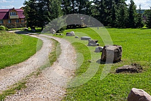 Boulders adorn the side of a rural road