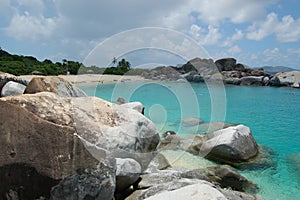 Boulders, beach and azure waters