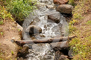 boulders in creek with water cascading over