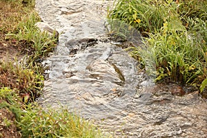 boulders in creek with water cascading over