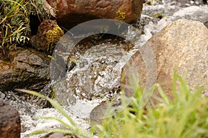boulders in creek with water cascading over