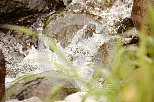 boulders in creek with water cascading over