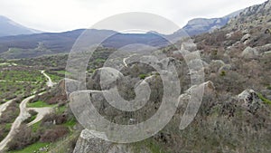 Boulders at foot of mountain. Shot. Drone view of extreme flight over boulders and rocks on mountain slopes. Natural