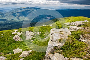 Boulders on a grassy slope of mountain ridge