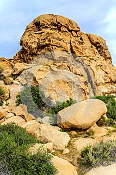 Boulders, red rock formations on the hiking trail in Joshua Tree National Park, California, United States.