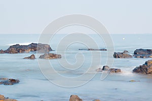 Boulders and stone laying in shallow water (sea