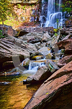 Boulders surrounded beautiful peaceful waterfalls small and large pouring over rocky cliffs