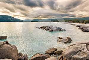 Boulders in a turquoise sea at Santa Giulia beach in Corsica