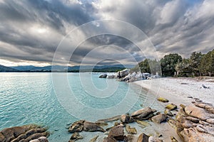 Boulders in a turquoise sea at Santa Giulia beach in Corsica