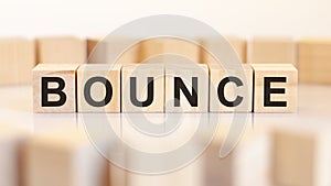 bounce - letters on wooden cubes on white background, concept