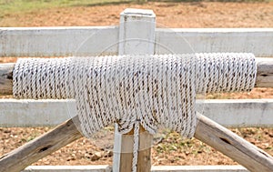 Bound with rope knot and wooden as fence in farmland.