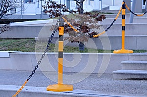 Boundary of plastic posts and chain at a stairway