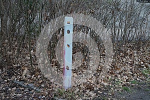 Boundary post on the road with the flag of the LGBT community. Berlin, Germany