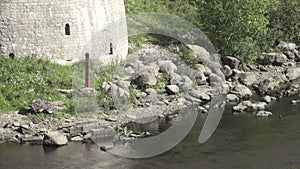 Boundary post of the Russian Federation on the river bank at fortress Ivangorod