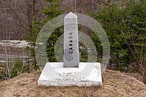 A boundary stone marks the US/Canada border