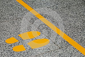 Boundary yellow line with a pointer where to stand