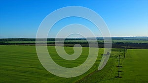 Boundless green rice field against distant village by pictorial hills