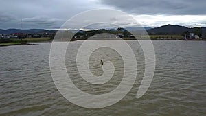 Boundless Lake Man Stands in Dugout Canoe Hills at Distance