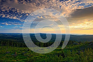 Bountiful morning sunrise in the Sumava Mountain, chop down forest on the hill, nice clouds on the sky, Knizeci Stolec, Czech