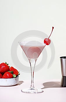 Bounty martini summer alcoholic cocktail drink with vodka, liqueur, cream, syrup, strawberries and ice in glass with cocktail